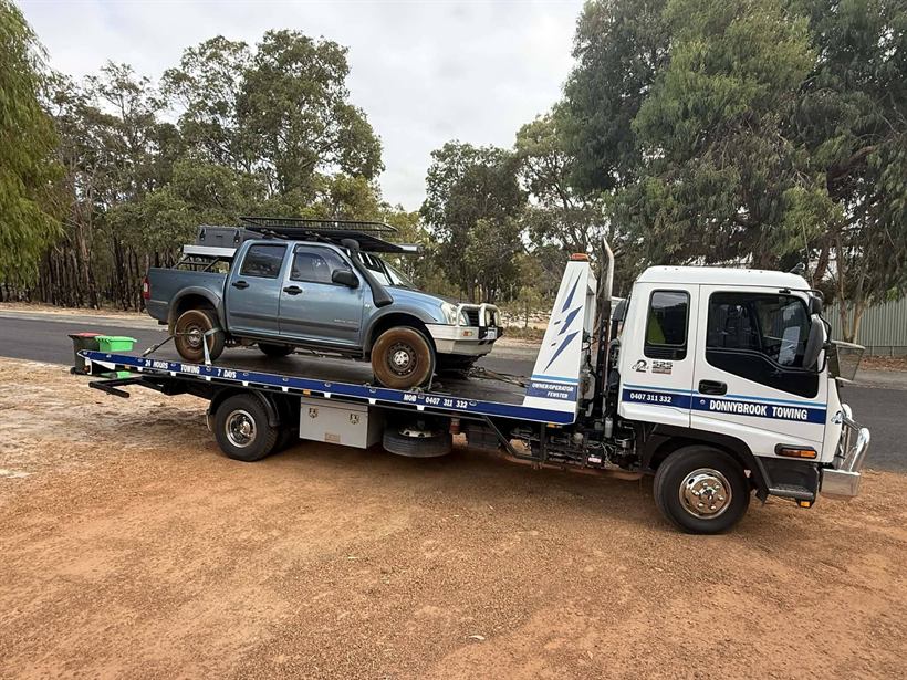 Dual cab 4WD ute on the tilt tray in the bush