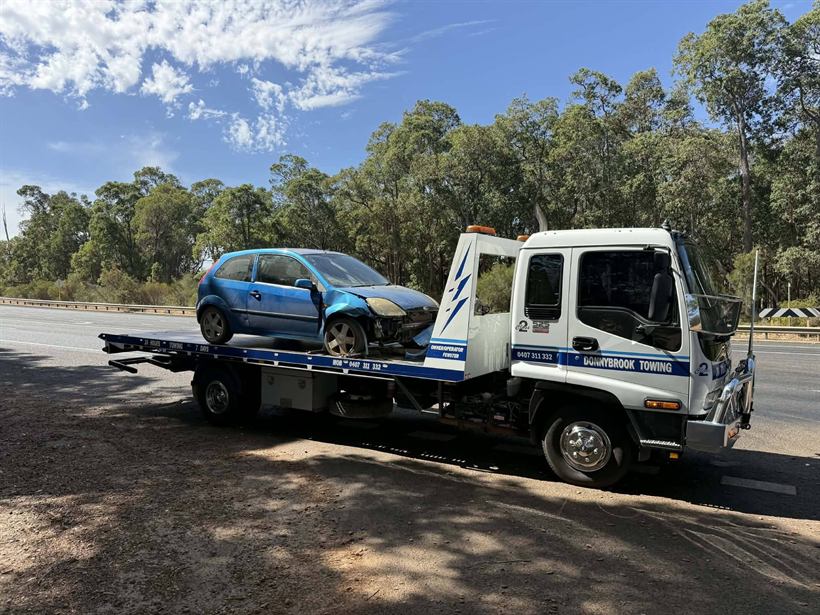Accident-damaged blue hatchback on the tilt tray