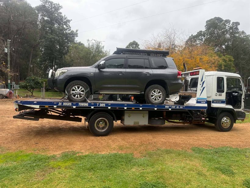 Black LandCruiser strapped on the tray